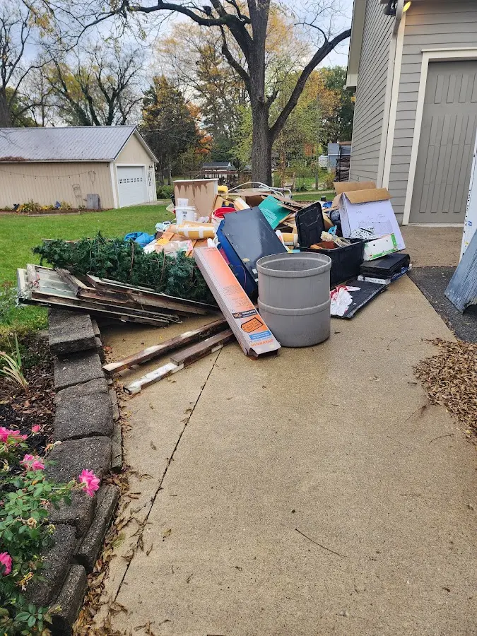 Dumpster being loaded with debris for 3 Yard Dumpster Rental in Longmont